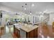 Modern kitchen with island, stone countertops, and open floor plan at 212 Blue Granite Dr, Holly Springs, NC 27540