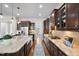 Gourmet kitchen with stainless appliances, granite counters, and bar stool seating at 212 Blue Granite Dr, Holly Springs, NC 27540