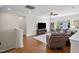 Spacious living room with hardwood floors, ceiling fan, and a comfortable seating area with a plush recliner at 212 Blue Granite Dr, Holly Springs, NC 27540