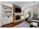 Bright living room with stone fireplace, built-ins, and ample seating at 212 Blue Granite Dr, Holly Springs, NC 27540