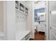 This is a mudroom with bench, storage, and view into a half bathroom with blue walls at 212 Blue Granite Dr, Holly Springs, NC 27540