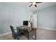 Cozy office with a ceiling fan, a computer desk, and a grey color scheme offering a modern, relaxing workspace at 212 Blue Granite Dr, Holly Springs, NC 27540