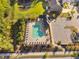 Aerial view of a sparkling community pool surrounded by lounge chairs, with lush landscaping and nearby parking at 212 Blue Granite Dr, Holly Springs, NC 27540