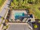 Aerial view of a sparkling community pool with lounge chairs and landscaping near the parking area at 212 Blue Granite Dr, Holly Springs, NC 27540