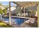 In-ground backyard pool with a slide, diving board, pergola, grill and an umbrella table at 212 Blue Granite Dr, Holly Springs, NC 27540