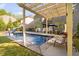 In-ground backyard pool featuring a slide, diving board, covered patio, and outdoor seating at 212 Blue Granite Dr, Holly Springs, NC 27540