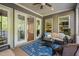 Cozy screened porch offers an indoor-outdoor space with view of the backyard at 212 Blue Granite Dr, Holly Springs, NC 27540