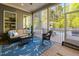 Relaxing screened-in porch with comfortable seating and a tranquil outdoor view at 212 Blue Granite Dr, Holly Springs, NC 27540