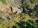 Aerial shot of home with expansive patio and lush surrounding greenery at 213 Huntington Dr, Chapel Hill, NC 27514