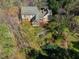 Aerial view of backyard featuring a patio, landscaped garden, and mature trees at 213 Huntington Dr, Chapel Hill, NC 27514