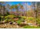 Lush backyard with a stream and mature trees offering privacy and tranquility, creating a serene outdoor oasis at 213 Huntington Dr, Chapel Hill, NC 27514