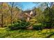 Stunning home exterior surrounded by lush landscaping and mature trees, creating a private and picturesque setting at 213 Huntington Dr, Chapel Hill, NC 27514