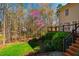 Scenic backyard featuring mature trees, vibrant foliage, and stairs leading to the home, creating a tranquil outdoor retreat at 213 Huntington Dr, Chapel Hill, NC 27514
