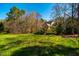 Expansive backyard with mature trees and lush greenery, providing privacy and a serene natural setting around the home at 213 Huntington Dr, Chapel Hill, NC 27514