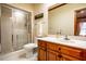 Bathroom with shower, toilet, and a wood vanity topped with a sink and mirror at 213 Huntington Dr, Chapel Hill, NC 27514
