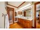 Bathroom with double sinks, wood cabinets, and framed mirrors at 213 Huntington Dr, Chapel Hill, NC 27514