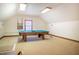 Large bonus room with a pool table and natural light at 213 Huntington Dr, Chapel Hill, NC 27514