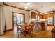 Open dining room area with hardwood floors adjoins a kitchen with an island and seating at 213 Huntington Dr, Chapel Hill, NC 27514