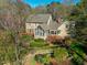 The home's sunroom and patio are nestled amongst mature trees and lush landscaping at 213 Huntington Dr, Chapel Hill, NC 27514