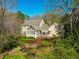 A charming home featuring a sunroom, patio, and mature, lush landscaping at 213 Huntington Dr, Chapel Hill, NC 27514