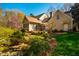 Charming home exterior with a patio, lush landscaping, and water feature, creating a peaceful and inviting outdoor living space at 213 Huntington Dr, Chapel Hill, NC 27514