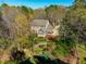 Aerial view of a charming home featuring lush landscaping and a private, wooded lot at 213 Huntington Dr, Chapel Hill, NC 27514