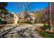 Traditional home with a gravel driveway, attached garage, mature trees, and attractive landscaping at 213 Huntington Dr, Chapel Hill, NC 27514