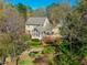 A charming home is surrounded by meticulous landscaping and a serene outdoor living space at 213 Huntington Dr, Chapel Hill, NC 27514