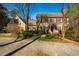 Inviting two-story home with manicured lawn, red door, mature landscaping, and charming curb appeal at 213 Huntington Dr, Chapel Hill, NC 27514