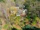 A beautiful exterior showcases the landscaped backyard, patio, and mature trees at 213 Huntington Dr, Chapel Hill, NC 27514