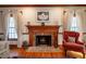 Close up on a wood burning fireplace in a large living room with hardwood floors at 213 Huntington Dr, Chapel Hill, NC 27514