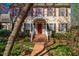 Welcoming front entrance featuring a brick walkway, a bright red door, and decorative floral accents at 213 Huntington Dr, Chapel Hill, NC 27514