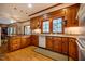 Traditional kitchen with wooden cabinets, granite countertops, and a bright window over the sink at 213 Huntington Dr, Chapel Hill, NC 27514