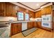 Kitchen with light stained wooden cabinetry, light countertops, and stainless steel appliances at 213 Huntington Dr, Chapel Hill, NC 27514