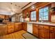 Kitchen with wooden cabinets, granite countertops, stainless steel appliances, and hardwood floors at 213 Huntington Dr, Chapel Hill, NC 27514