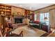 Spacious living room featuring a cozy brick fireplace and custom built-in shelving at 213 Huntington Dr, Chapel Hill, NC 27514