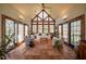 Spacious sunroom features tile floors, light-colored sofas, and large windows for natural light at 213 Huntington Dr, Chapel Hill, NC 27514