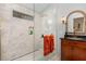 Luxury bathroom features an updated shower with white subway tile and bronze fixtures and new sink vanity at 227 Windlestraw, Pittsboro, NC 27312