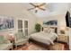 Cozy bedroom with a ceiling fan, plush rug, plantation shutters, and vaulted ceilings at 227 Windlestraw, Pittsboro, NC 27312