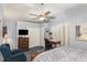 Spacious bedroom with blue carpet, desk, a ceiling fan, and lots of storage space at 227 Windlestraw, Pittsboro, NC 27312