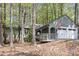 Charming home featuring a spacious two-car garage and welcoming front porch, nestled among beautiful trees at 227 Windlestraw, Pittsboro, NC 27312