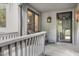 Covered front porch with seating area and a view of the entry door to the home at 227 Windlestraw, Pittsboro, NC 27312
