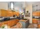 Kitchen shows stainless steel appliances, wood cabinets, granite countertops and a view to the eating nook at 227 Windlestraw, Pittsboro, NC 27312