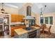 Well-equipped kitchen features stainless steel appliances and center island cooktop and attached breakfast nook at 227 Windlestraw, Pittsboro, NC 27312
