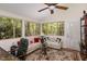 Open and bright living room features multiple windows, hardwood floors, and neutral-toned furniture at 227 Windlestraw, Pittsboro, NC 27312