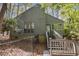 View of the back of home and a fenced yard, featuring a deck and stairs to grade at 227 Windlestraw, Pittsboro, NC 27312
