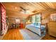 Spacious bedroom with wood paneling, ceiling fan, and natural light, creating a cozy and inviting atmosphere at 2281 Lamont Norwood, Pittsboro, NC 27312