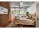 Spacious bedroom featuring a bed, brick accents and a well-lit window at 2281 Lamont Norwood, Pittsboro, NC 27312