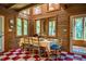 Bright dining room with wood paneling, checkered floors, and skylight at 2281 Lamont Norwood, Pittsboro, NC 27312