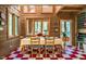 Charming dining room featuring wood paneling, checkered floors, and bright natural light at 2281 Lamont Norwood, Pittsboro, NC 27312